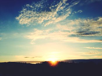 Scenic view of landscape against sky at sunset