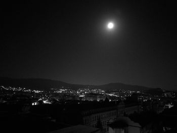 Illuminated city against sky at night