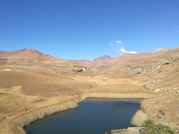 Scenic view of mountains against clear blue sky