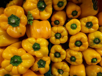 Full frame shot of yellow bell peppers for sale at market stall