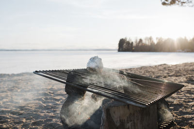 Food cooking on an outdoor fire at the beach at sunset in sweden