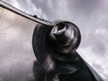 Low angle view of slide against cloudy sky