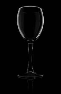 Close-up of wineglass against black background