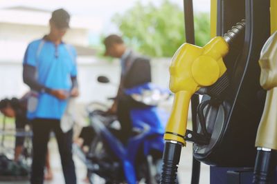 Men at fuel pump