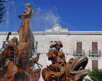 View of a beautiful gushing fountain in ortigia, sicily