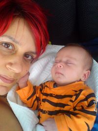 High angle view of baby girl lying on bed