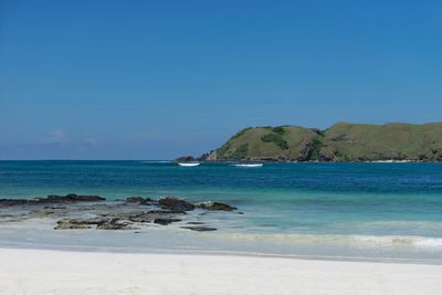 Scenic view of sea against clear blue sky