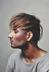 Portrait of young man against white background