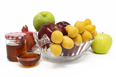 Rosh hashanah jewish new year traditional symbols, honey in a glass jar, pomegranates, dates, apple