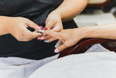 Woman getting a manicure in beauty spa salon