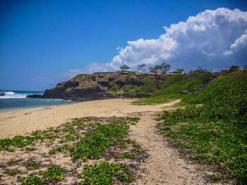 Scenic view of beach against blue sky