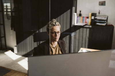 Mature female professional wearing eyeglasses working in office