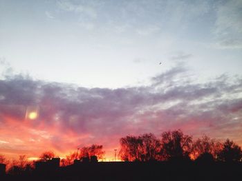 Silhouette of trees against sky at sunset