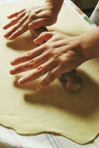 Close-up of man rolling dough with pin