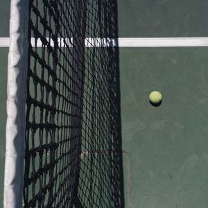 Ball and net on tennis court