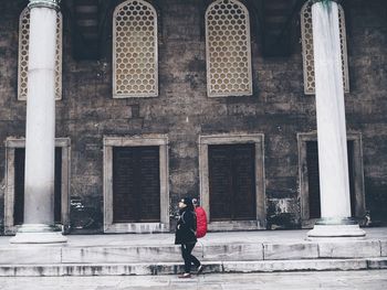 Full length of woman standing in front of building