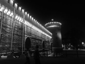 Low angle view of illuminated building against sky at night