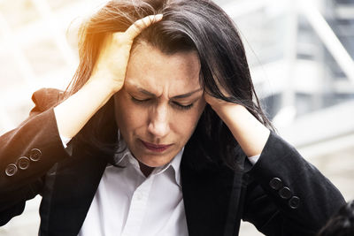 Frustrated businesswoman with hand in hair