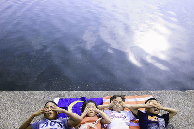 High angle view of children lying malaysian flag