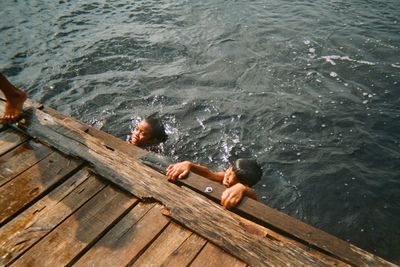 High angle view of man swimming on pier over sea