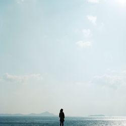 Rear view of woman standing on beach