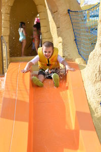 Full length of excited boy on slide at hersheypark