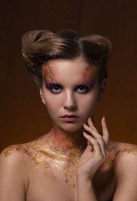 Portrait of woman with glitter make-up