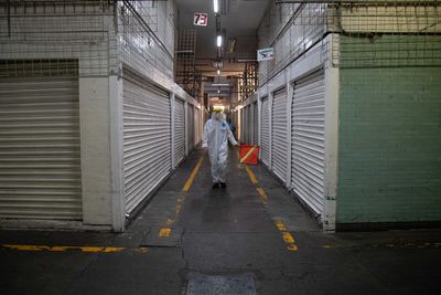 Rear view of man working on escalator in building