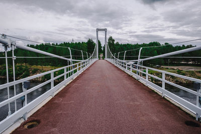 Footbridge over road against sky