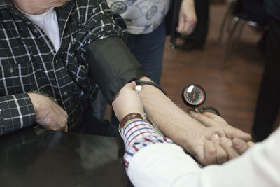 Cropped image of doctor examining patient in hospital