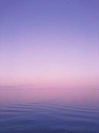 Scenic view of sea against romantic sky at sunset