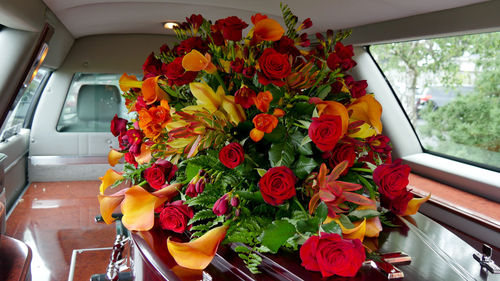 Close-up of red roses in car