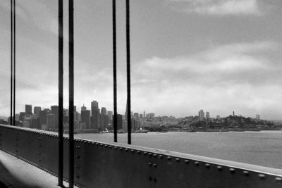 View of suspension bridge against cloudy sky