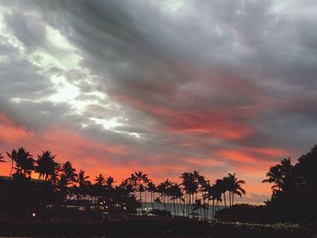 Silhouette palm trees against sky during sunset