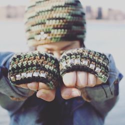 Close-up of person with knitted gloves