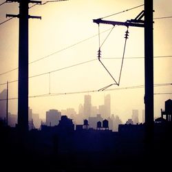 Silhouette of building against sky at sunset