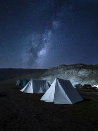 Tent on field against sky at night