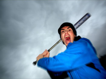 Low angle view of man standing against sky