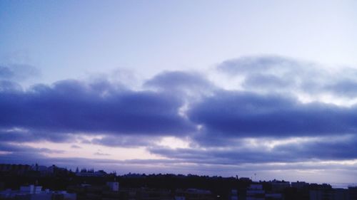 Cityscape against cloudy sky