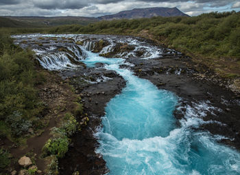 High angle view of water flowing through rocks