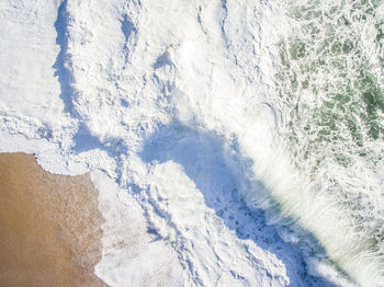 Drone view of wave splashing at beach