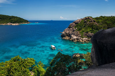 Tourist snorkeling at coral reef with turquoise sea water in summer, similan island, phang nga