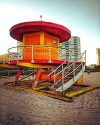 Lifeguard hut on beach against sky