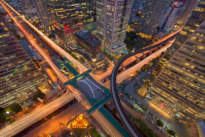 Aerial view of illuminated cityscape during sunset