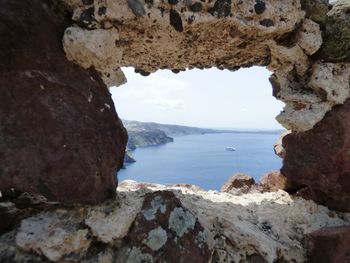 Rock formations by sea against sky