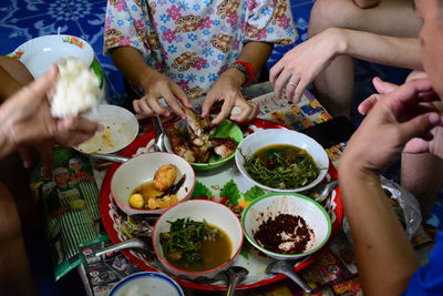 Midsection of people having food