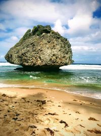 View of rocks on beach against sky