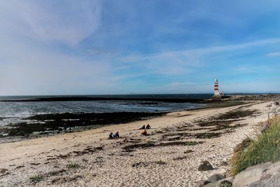 Scenic view of beach against blue sky