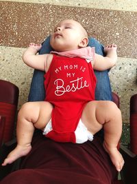 Midsection of woman with toddler sitting on chair