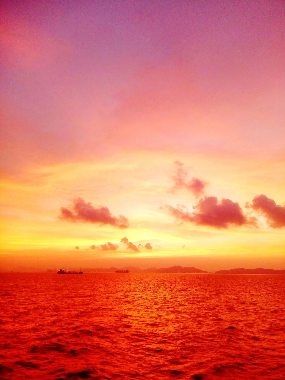 SCENIC VIEW OF SEA AGAINST ORANGE SKY DURING SUNSET